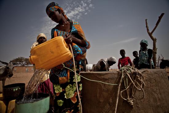 Refilling water bucket from a well in Mauritania - OXFAM